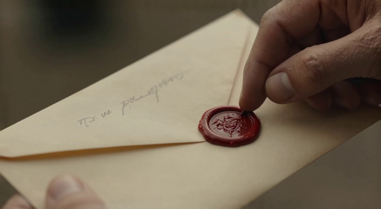 A hand holding a sealed letter, a still from Filmoyo’s public demo film The Letter